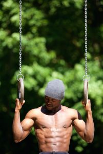 African american man workout routine on gymnast rings
