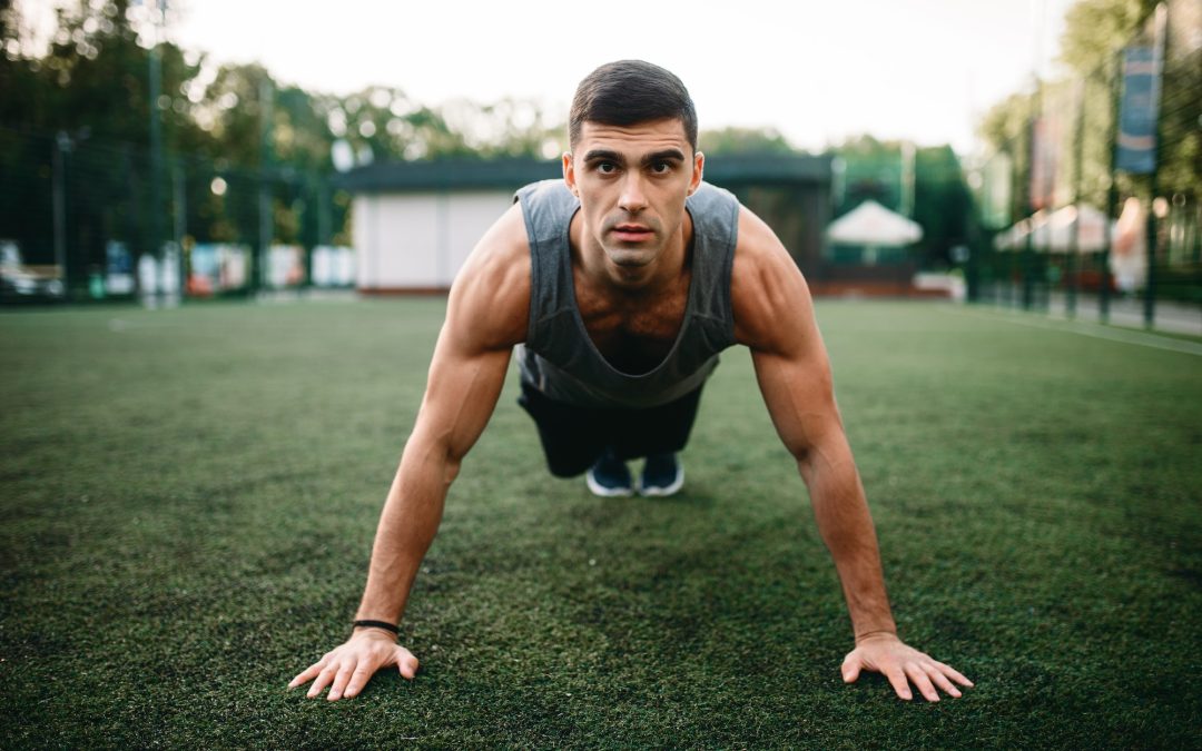 Athlete doing push-up exercise on outdoor workout